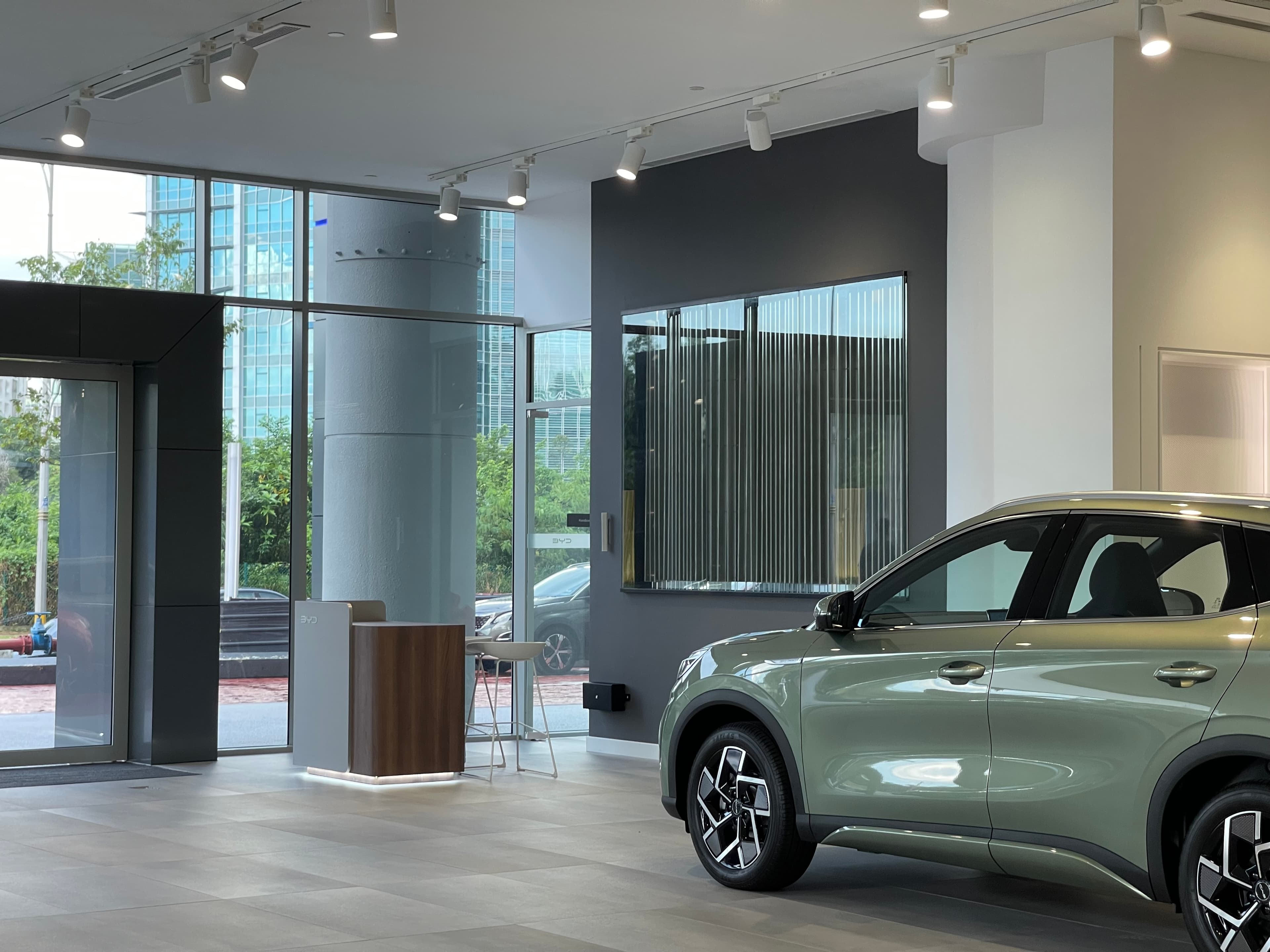 BYD × Nextrend limited edition loudspeakers beside a performance EV